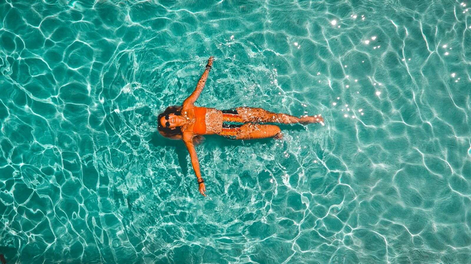 woman swimming alone in body of water